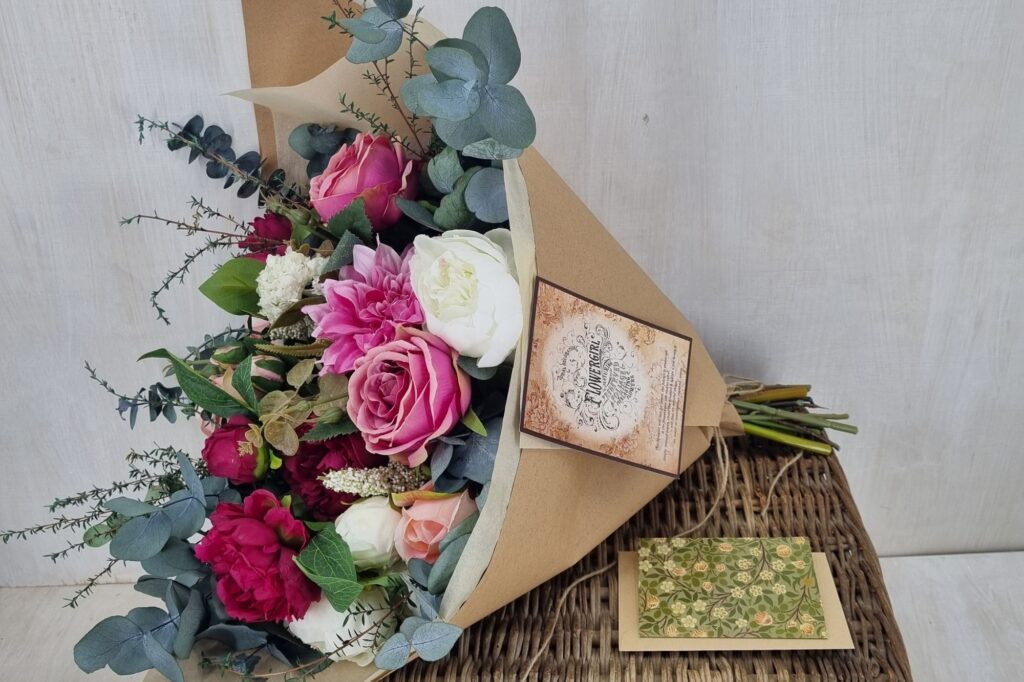 sustainably gift wrapped flowergirl  large romantic bouquet in brown paper 