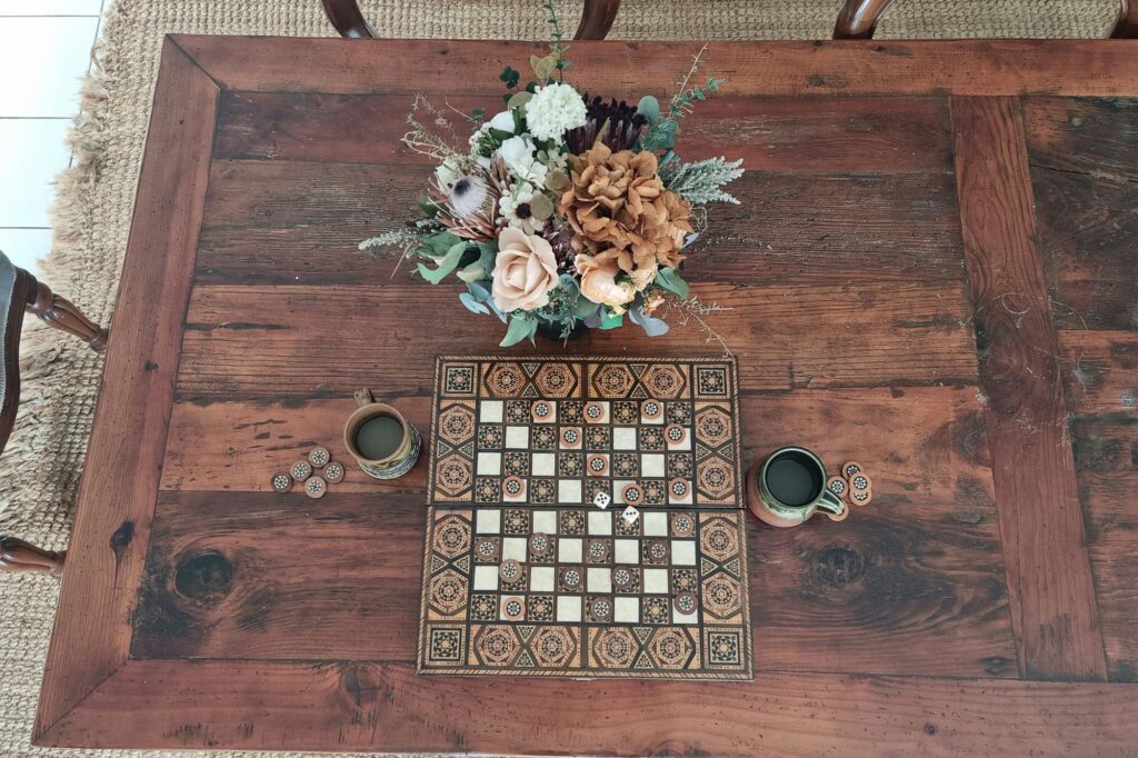 flowergirl earthy bouquet on family table with a game of checkers