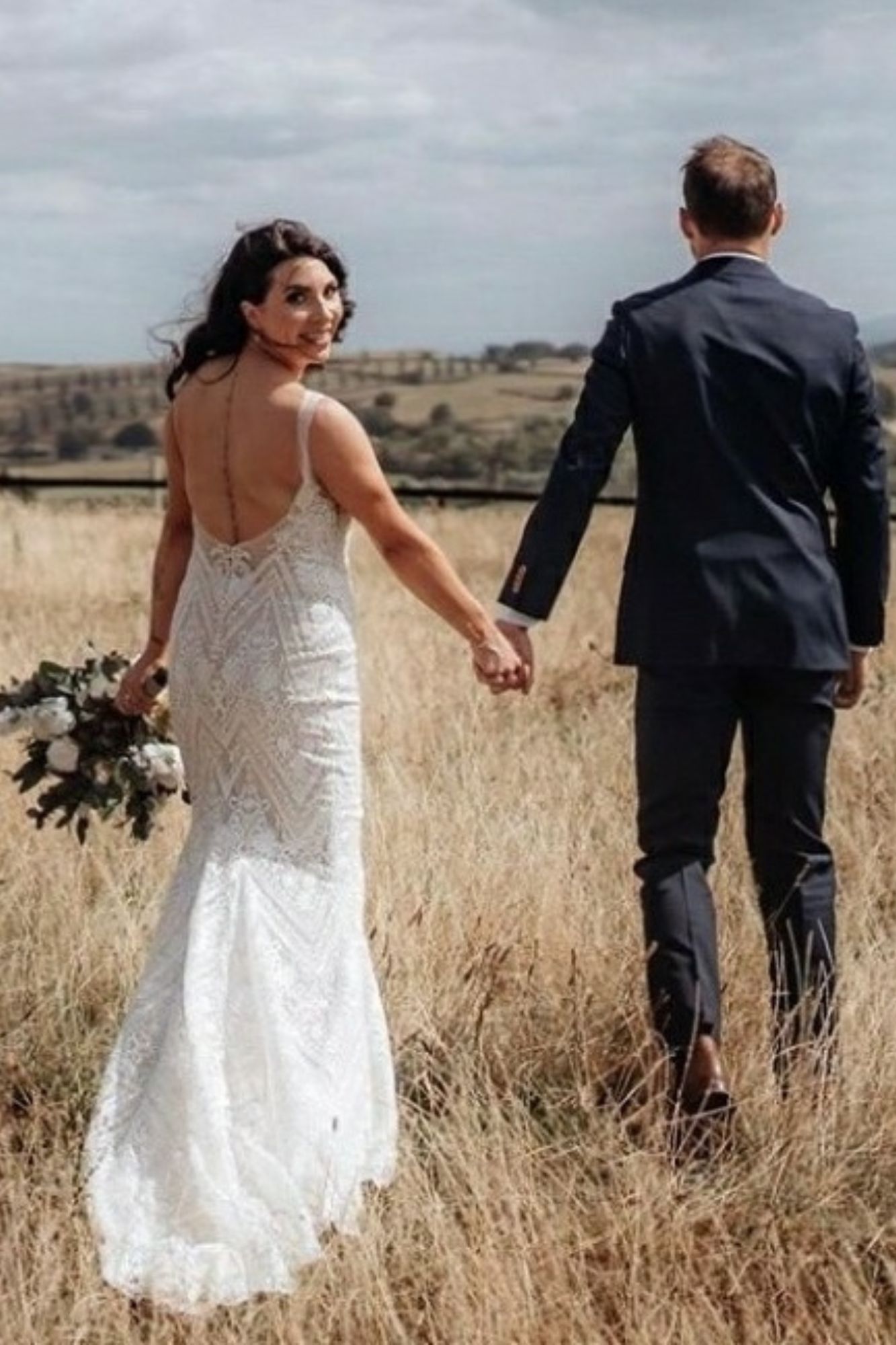 Flowergirl bride and groom with preserved foliage and artificial flower wedding arrangement