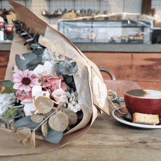 An everlasting posy in a cafe with a coffee